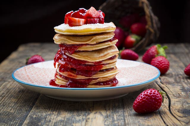 Pancakes with strawberry sauce and strawberries