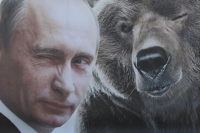 A portrait of a winking Russian President Vladimir Putin and a bear at Victory Park on 8 May, 2015