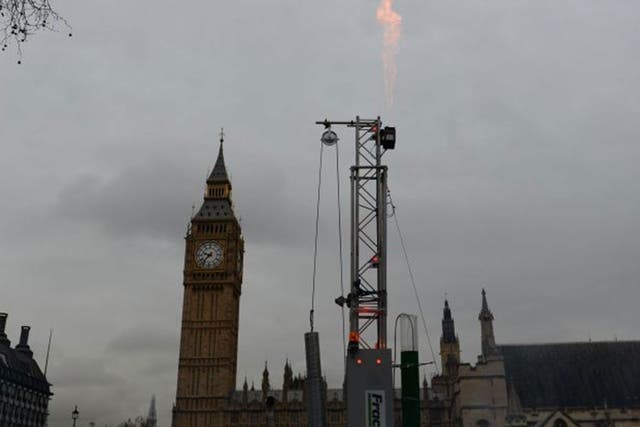 Flames spurt from an imitation fracking rig and drill installed by Greenpeace activists in Parliament Square, central London. The shale-extracting technique could take place near the North York Moors