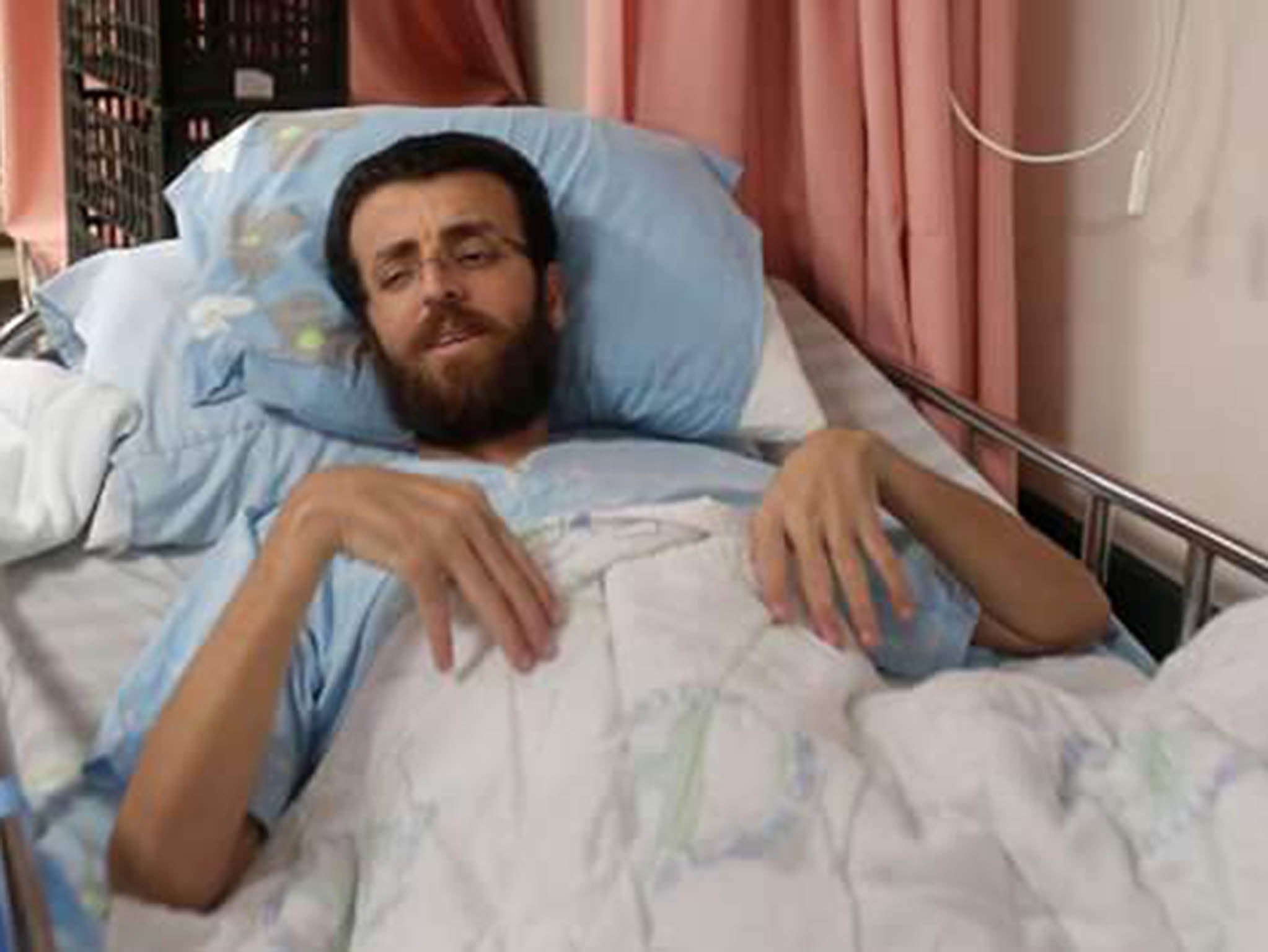 Mohammed Al-Qeeq has been on hunger strike for 77 days and has been refused a transfer from an Israeli hospital to Raallah hospital in Palestine