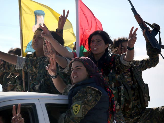 Yazidi soldiers cheer a fallen comrade on November 15, 2015 near Sinjar, Iraq