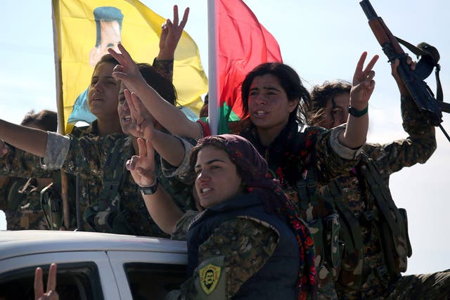 Yazidi soldiers cheer a fallen comrade on November 15, 2015 near Sinjar, Iraq