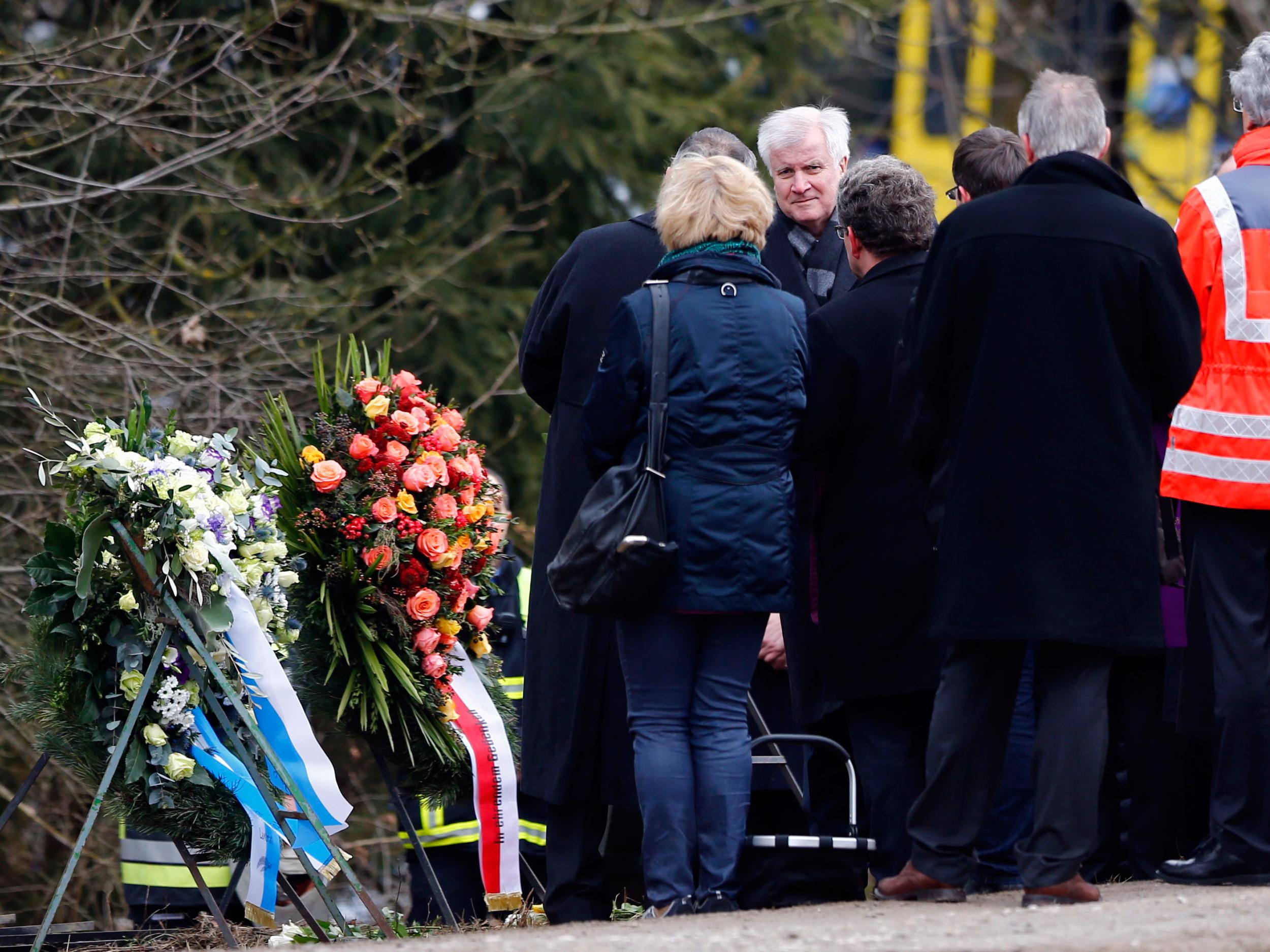 Bavarian state governor Horst Seehofer, third left, arrives at the site where two trains collided head-on near Bad Aibling, Germany AP