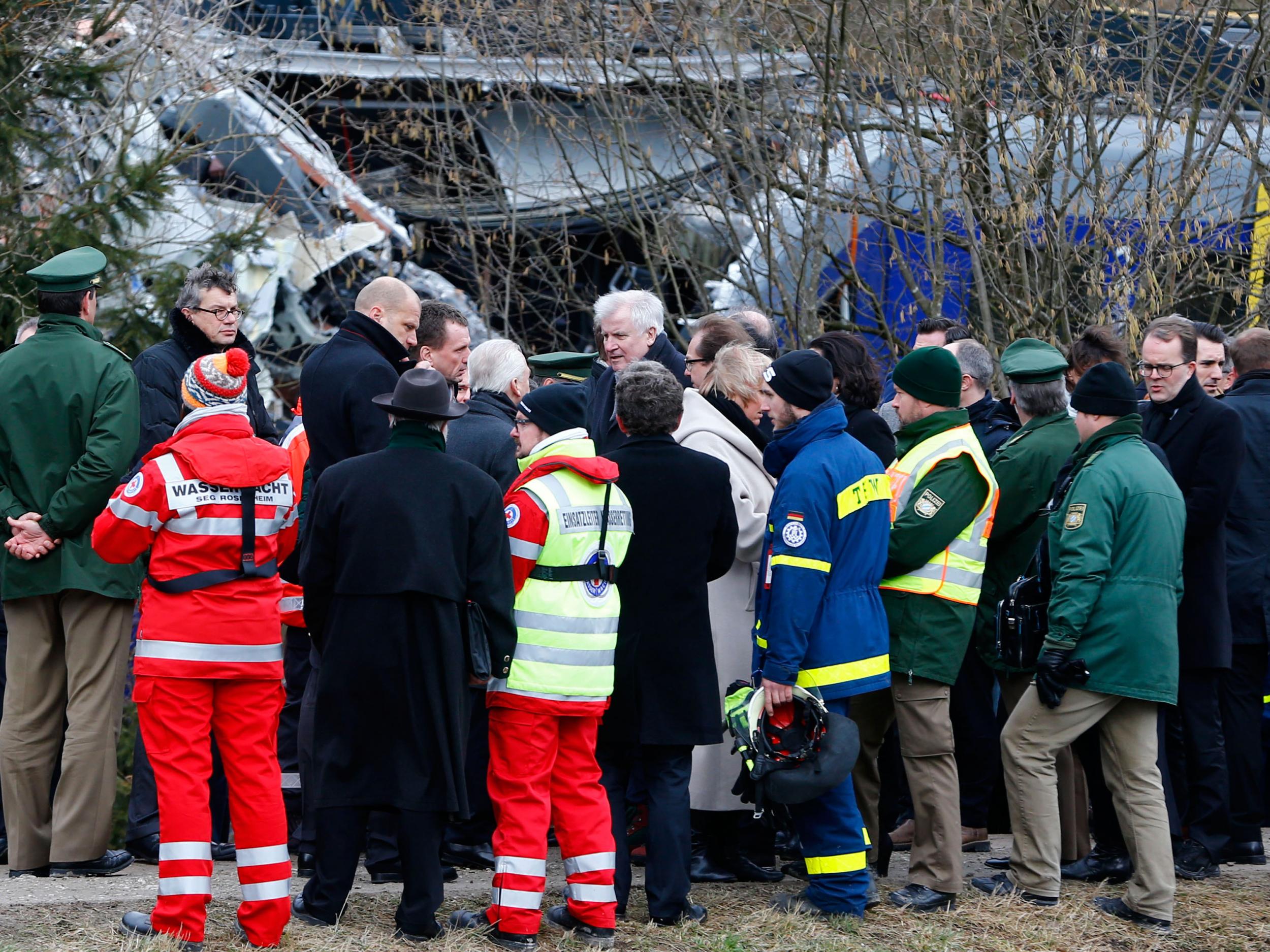 Bavarian state governor Horst Seehofer, center, arrives at the site where two trains collided head-on near Bad Aibling, Germany