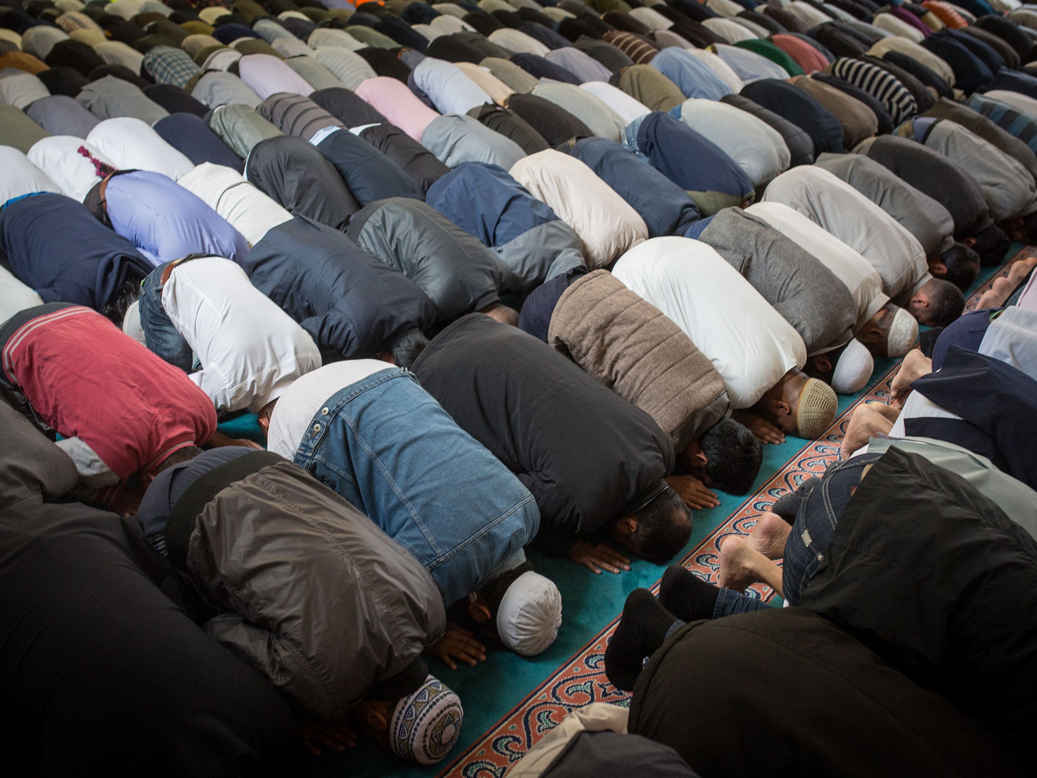 Men attend the first Friday prayers of Ramadan in East London, 2015