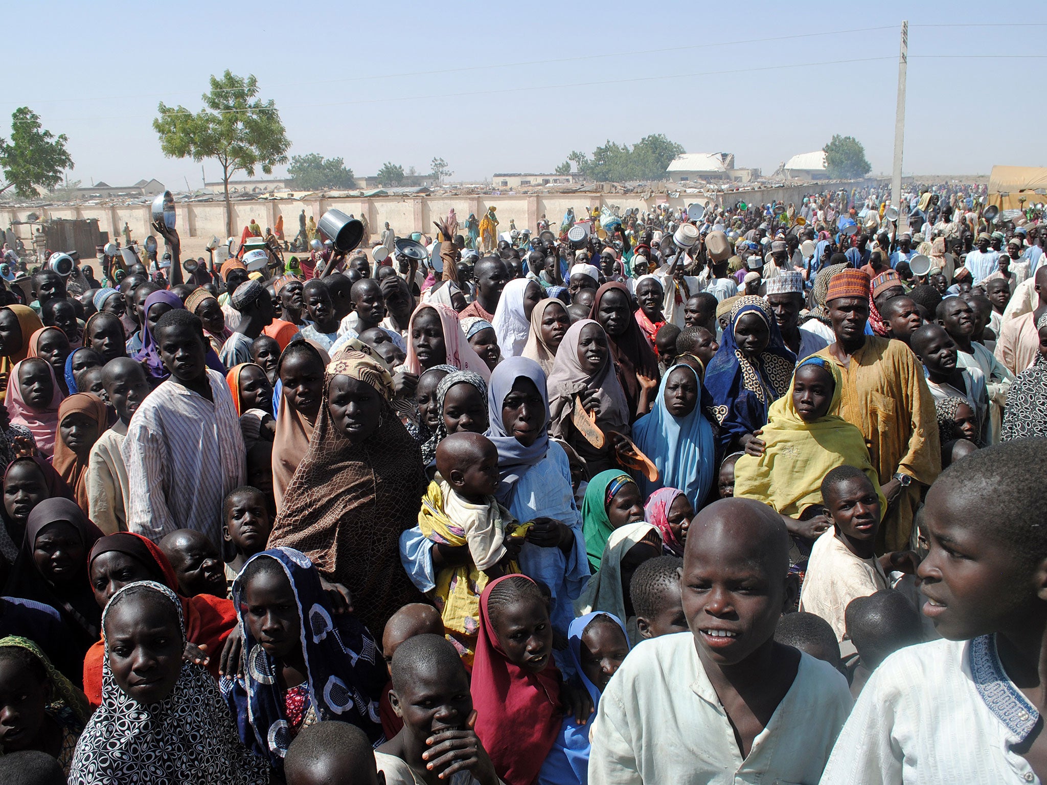 Internally Displaced Persons (IDP) mostly women and children stand waiting for food at Dikwa Camp, in Borno State in north-eastern Nigeria, on 2 February, 2016