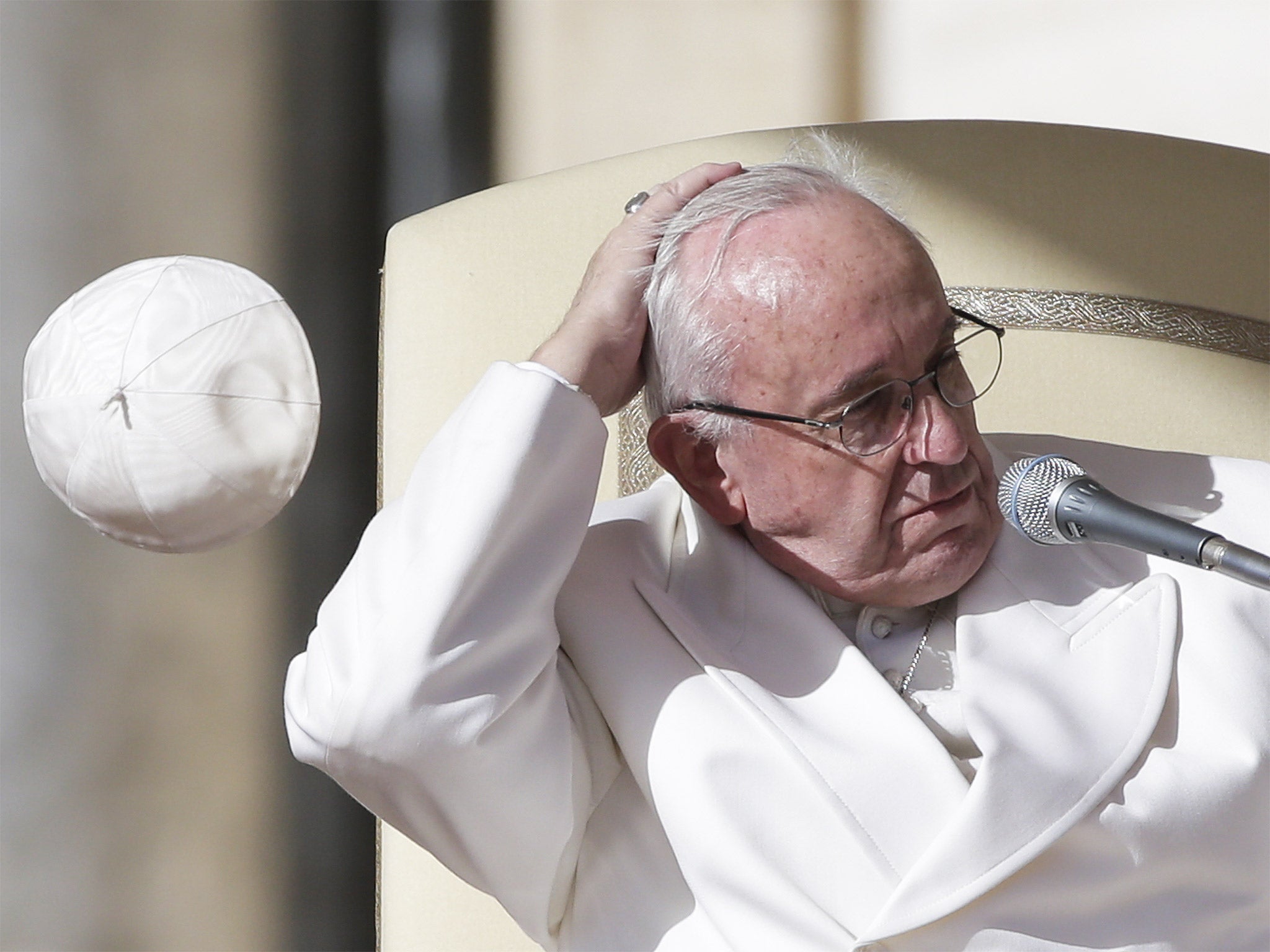 Pope Francis, here losing his skullcap in Saint Peter’s Square, visits Latin America later this week