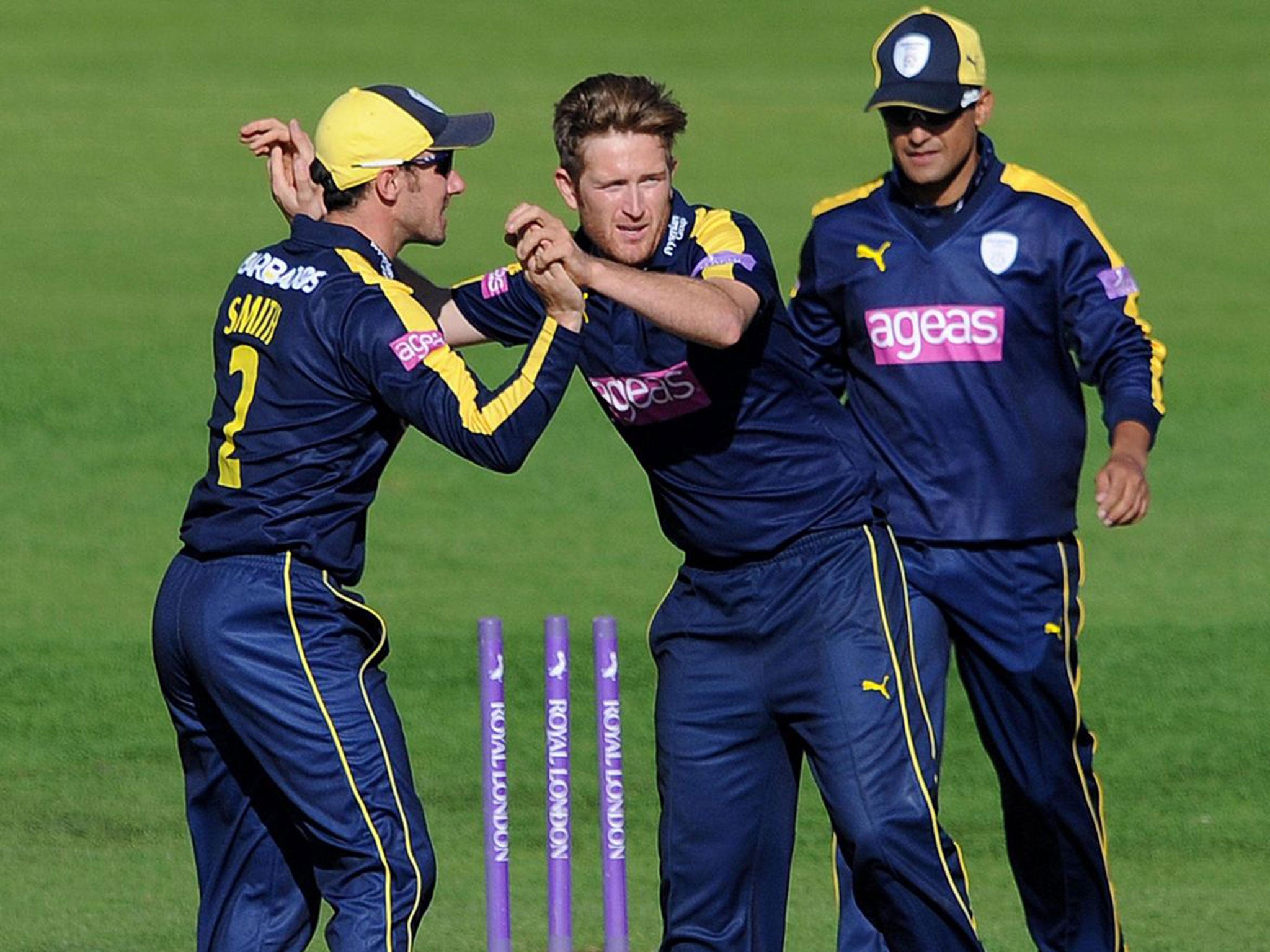 Liam Dawson (centre) celebrates taking a wicket for Hampshire