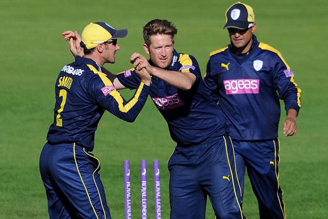 Liam Dawson (centre) celebrates taking a wicket for Hampshire