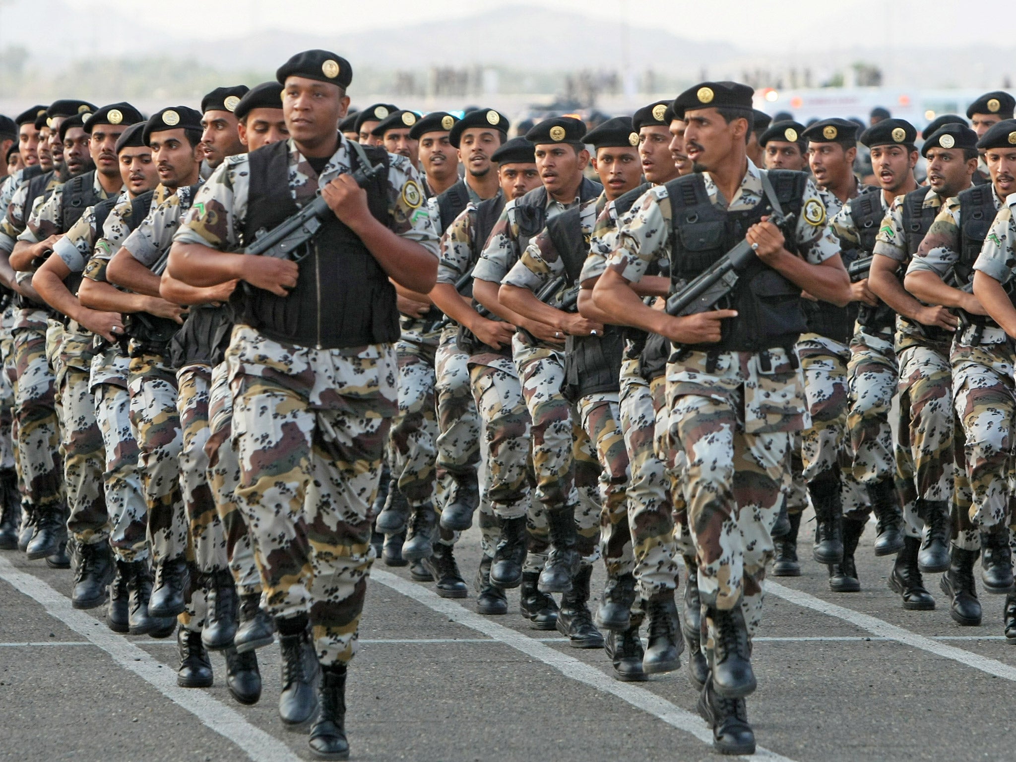 Saudi security forces march during a military parade