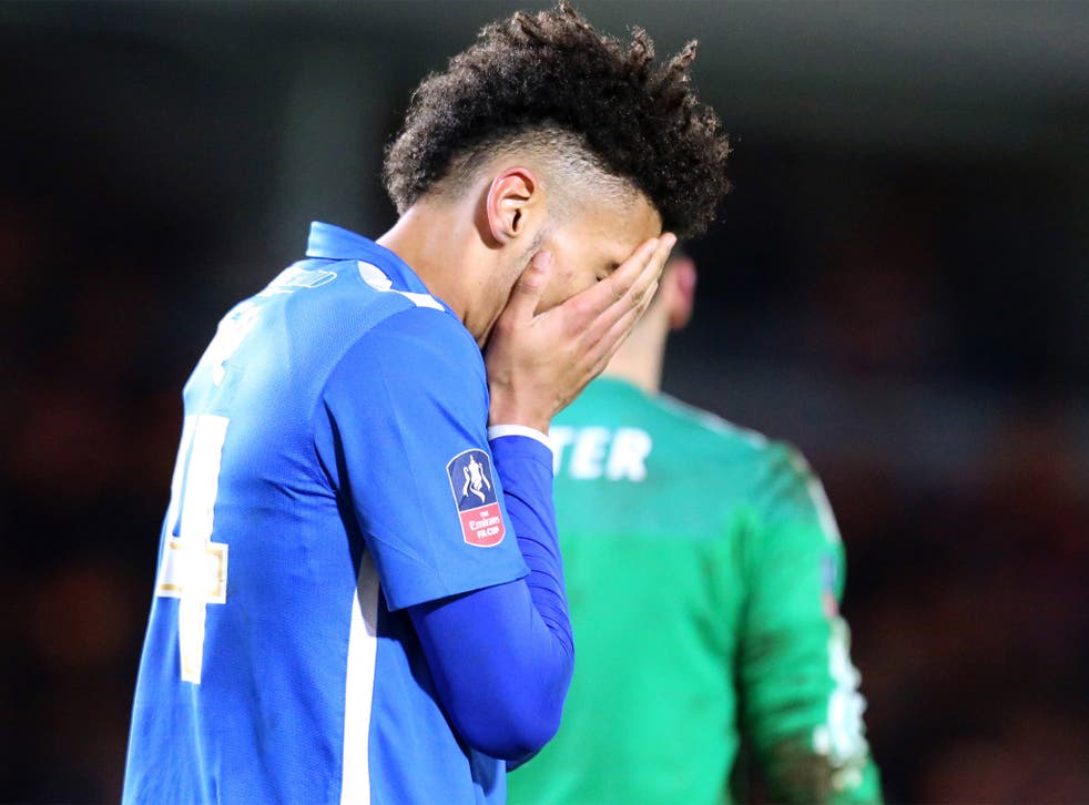 Peterbourough's Lee Angol looks dejected after seeing his penalty saved
