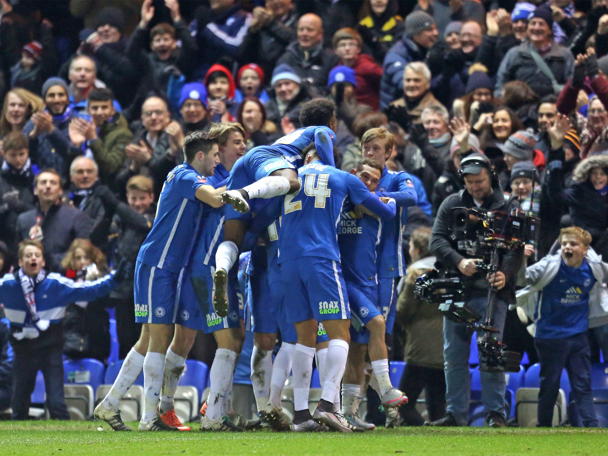 &#13;
Jon Taylor, second from right, celebrates with teammates after putting the Posh in front &#13;