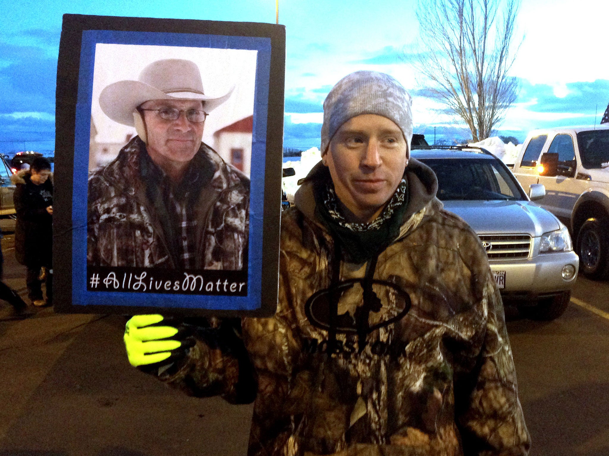 A supporter holds a photo of LaVoy Finicum, who was killed during a standoff with police