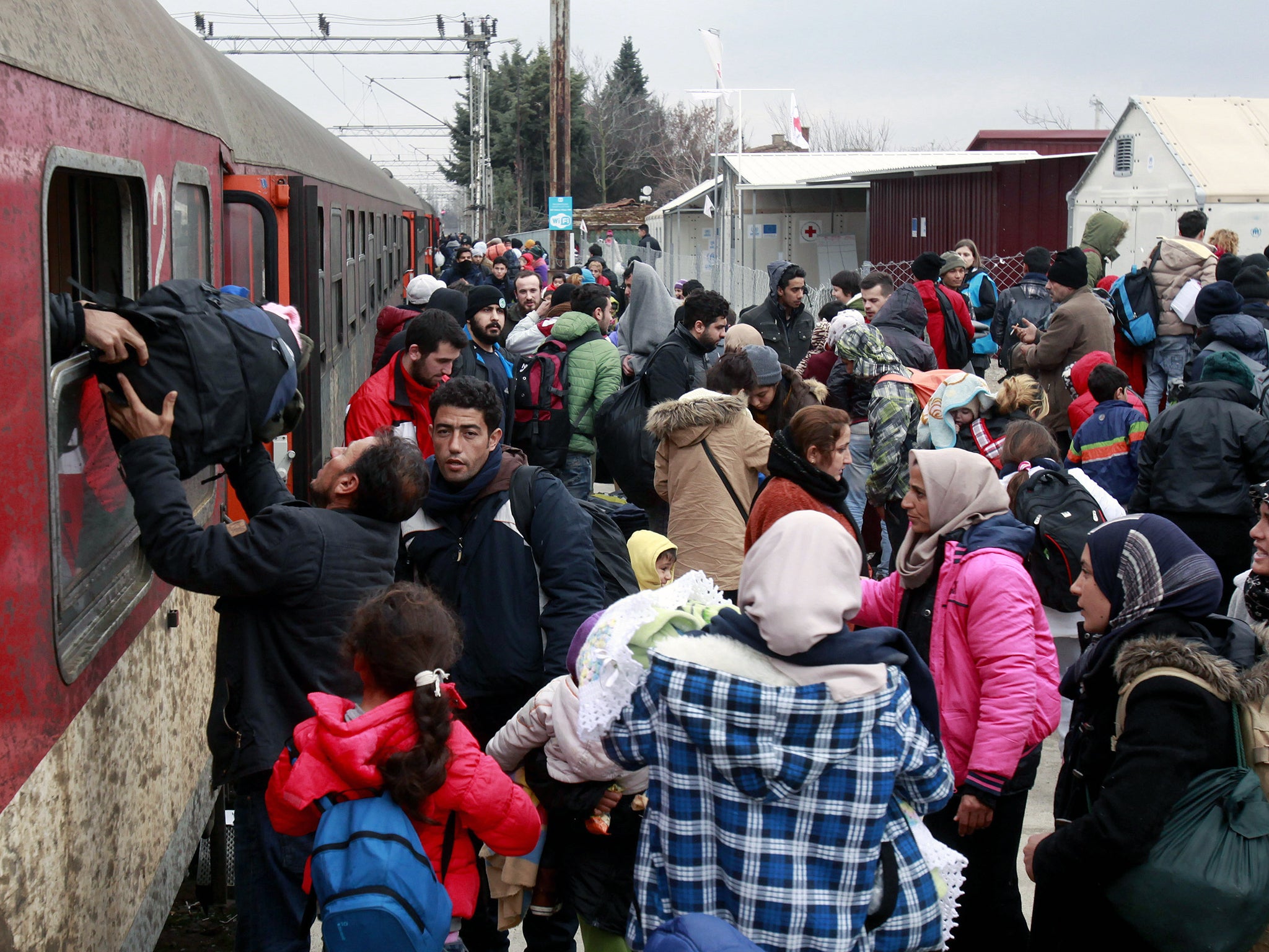 Refugees arrive by train at the transit center for refugees near northern Macedonian village of Tabanovce, before continuing their journey to Serbia