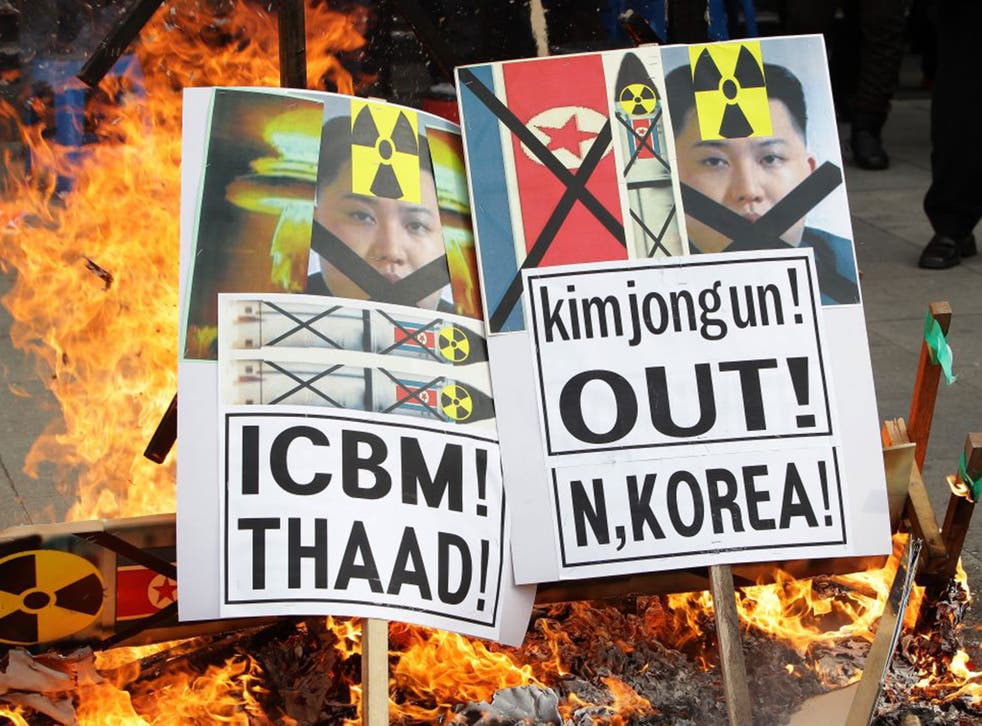 South Korean protesters burning placards of Kim Jong-un at an anti-North Korea rally in Seoul, South Korea, as relations between the two countries deteriorated
