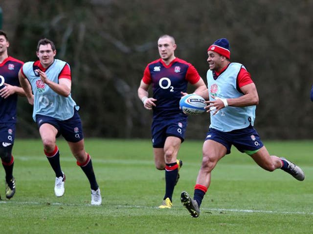Jonathan Joseph, with ball, trains with England at Pennyhill Park