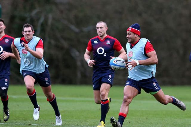 Jonathan Joseph, with ball, trains with England at Pennyhill Park