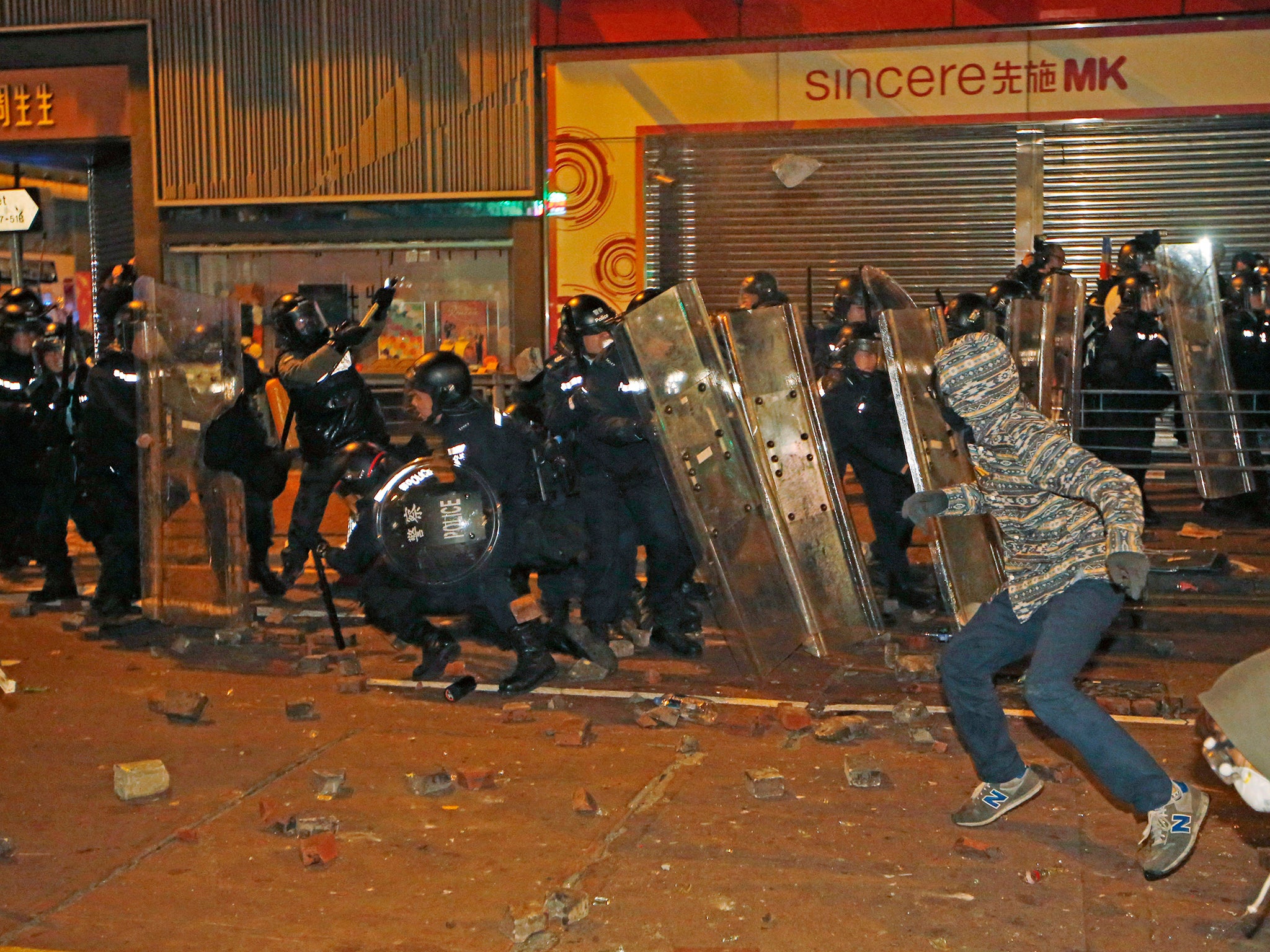 &#13;
A rioter throws brick at police on a street in Mong Kok district of Hong Kong, Tuesday, Feb. 9, 2016.&#13;