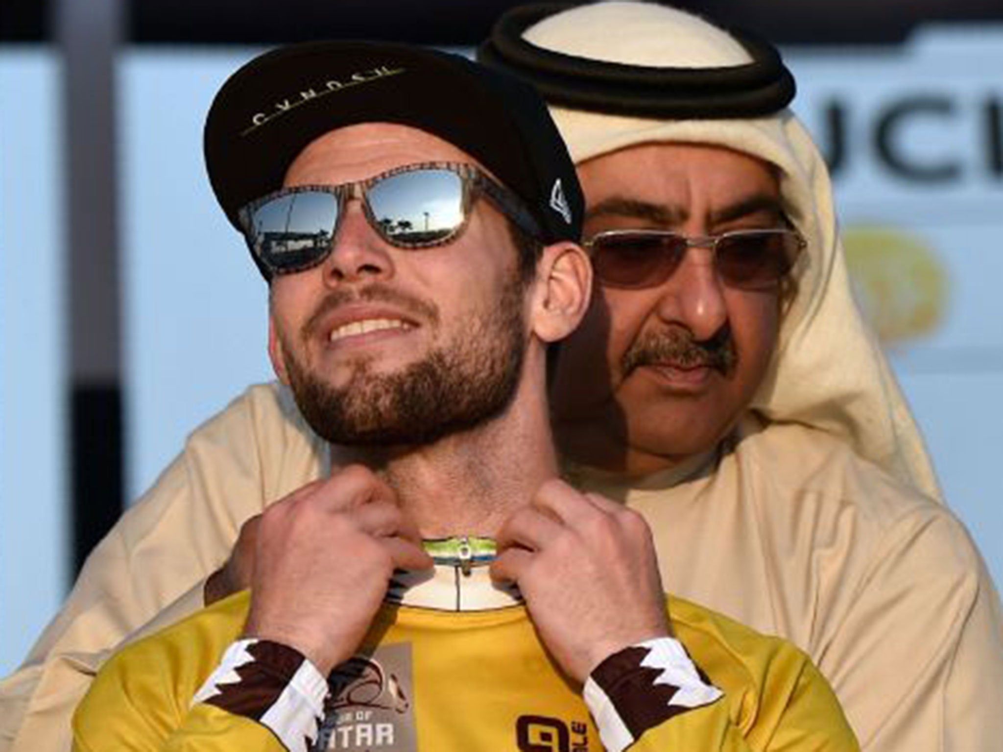 Mark Cavendish receives the winner’s gold jersey in Qatar