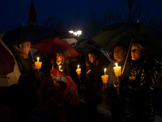 People gather during a candle light procession to honor the memory of  Giulio Regeni in Fiumicello, Italy,