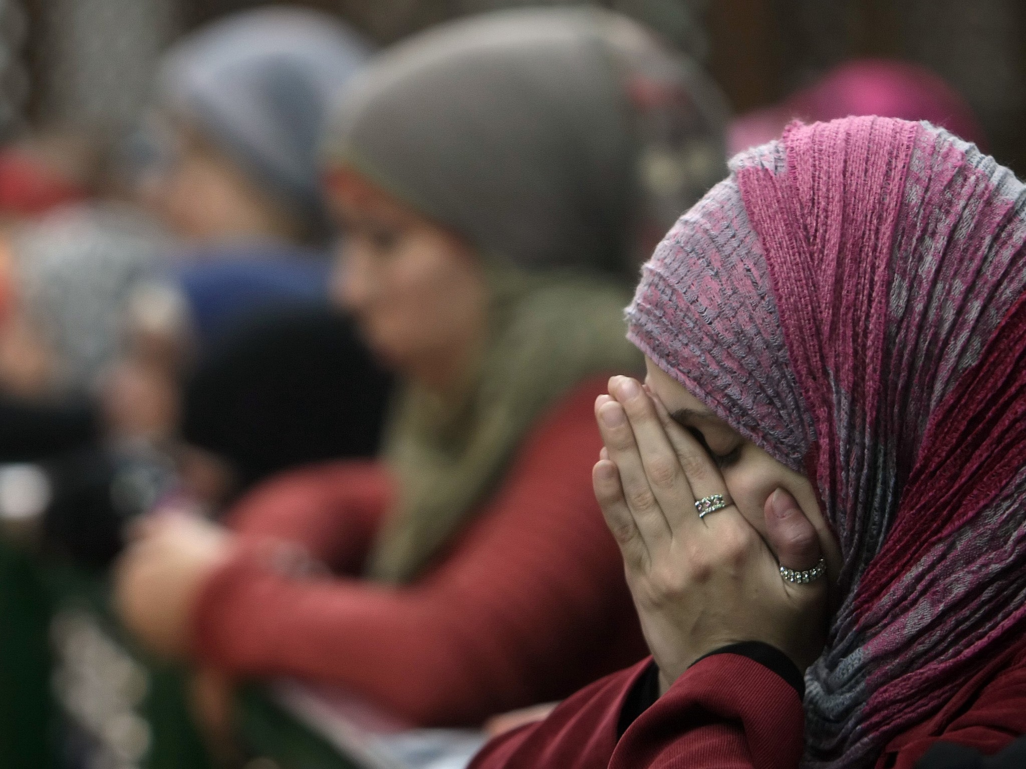 Girls adjust their headscarves before an Islamic prayer service for News  Photo - Getty Images