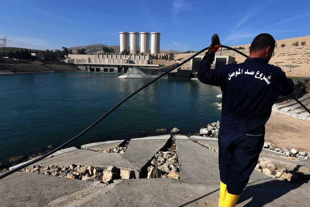 An employee works at strengthening the Mosul Dam