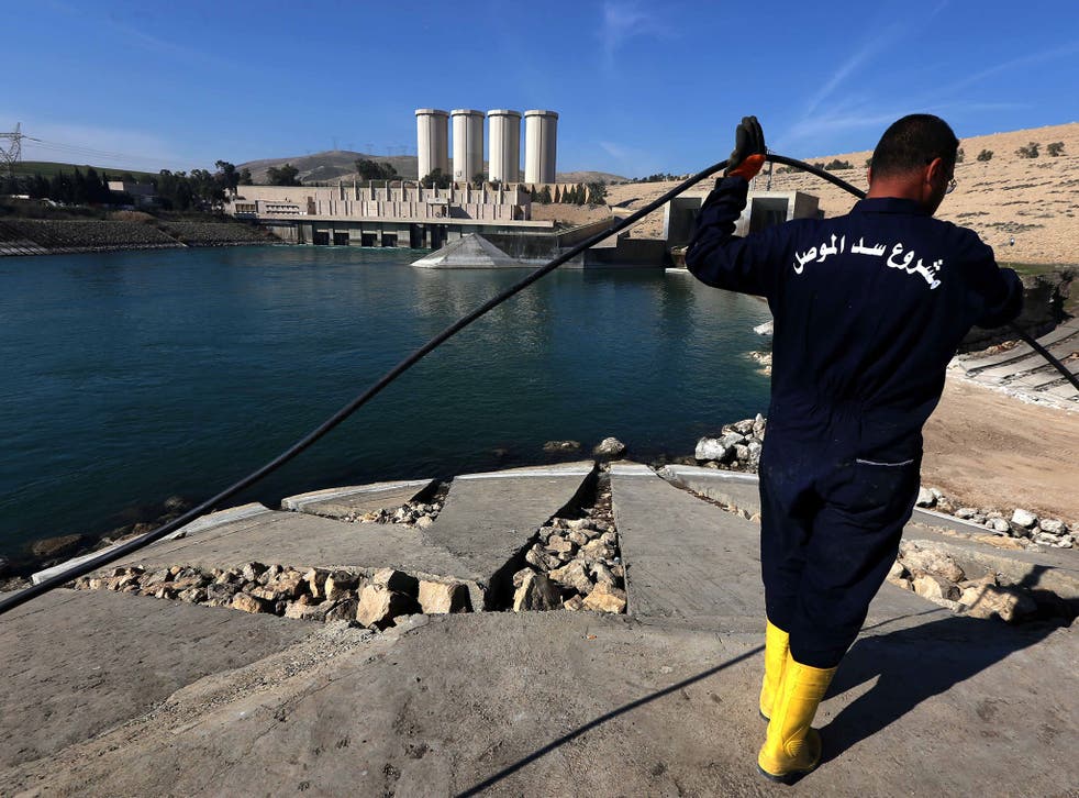 An employee works at strengthening the Mosul Dam