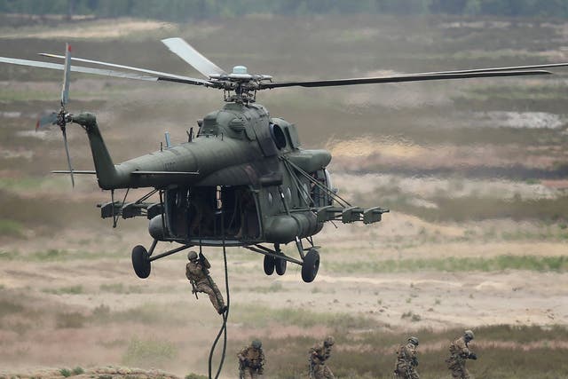 Soldiers of the Polish Army descend from an MI-8 helicopter during the NATO Noble Jump military exercises of the VJTF forces