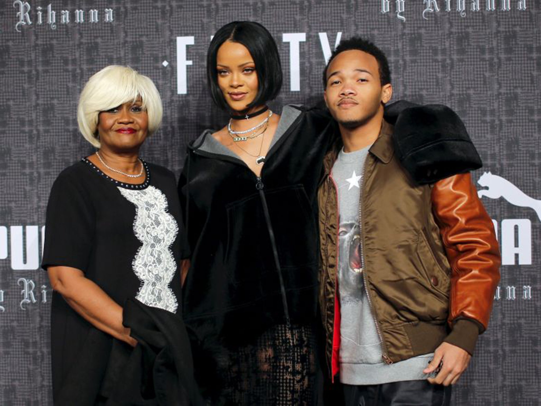 Rihanna, centre, with her mother Monica Fenty, left, and brother Rajad Fenty on the red carpet before the Fenty PUMA by Rihanna 2016 show