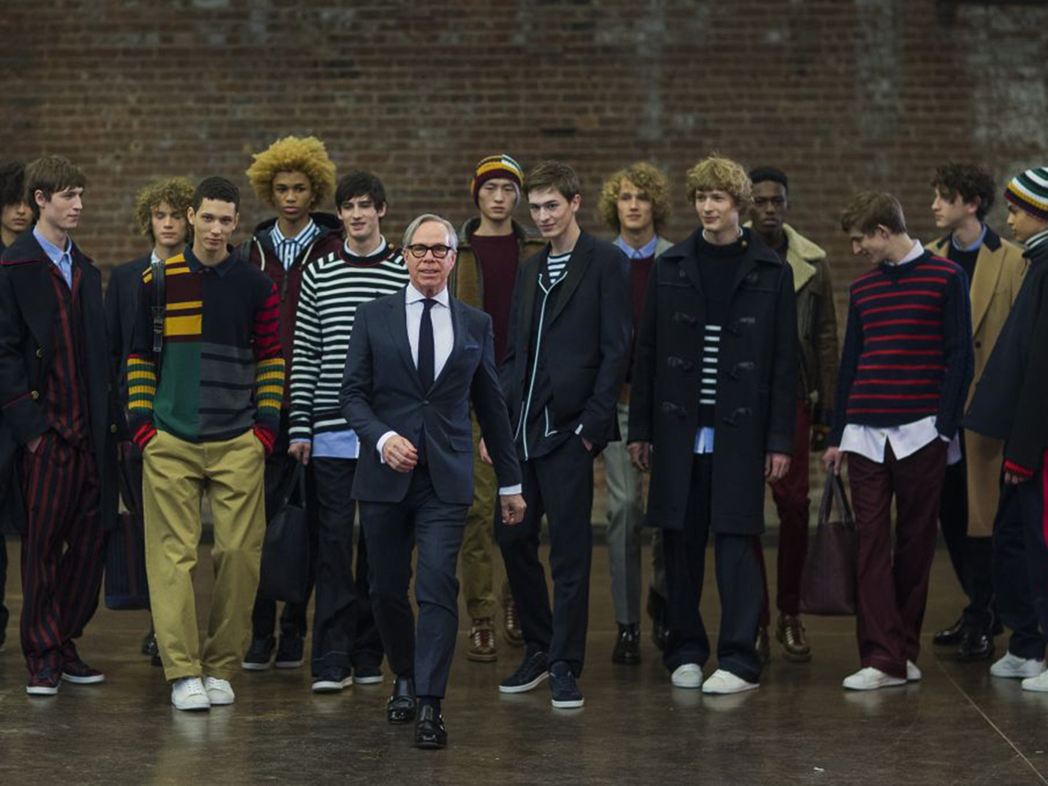 Tommy Hilfiger, front, with his models