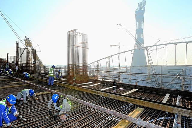 Workers on the Khalifa International Stadium for Qatar’s 2022 World Cup
