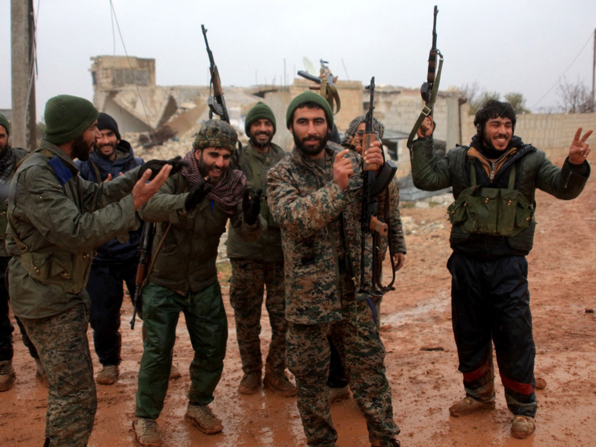 Syrian government soldiers celebrate after taking control of the village of Ratian, north of the embattled city of Aleppo, from rebel fighters on 6 February, 2016