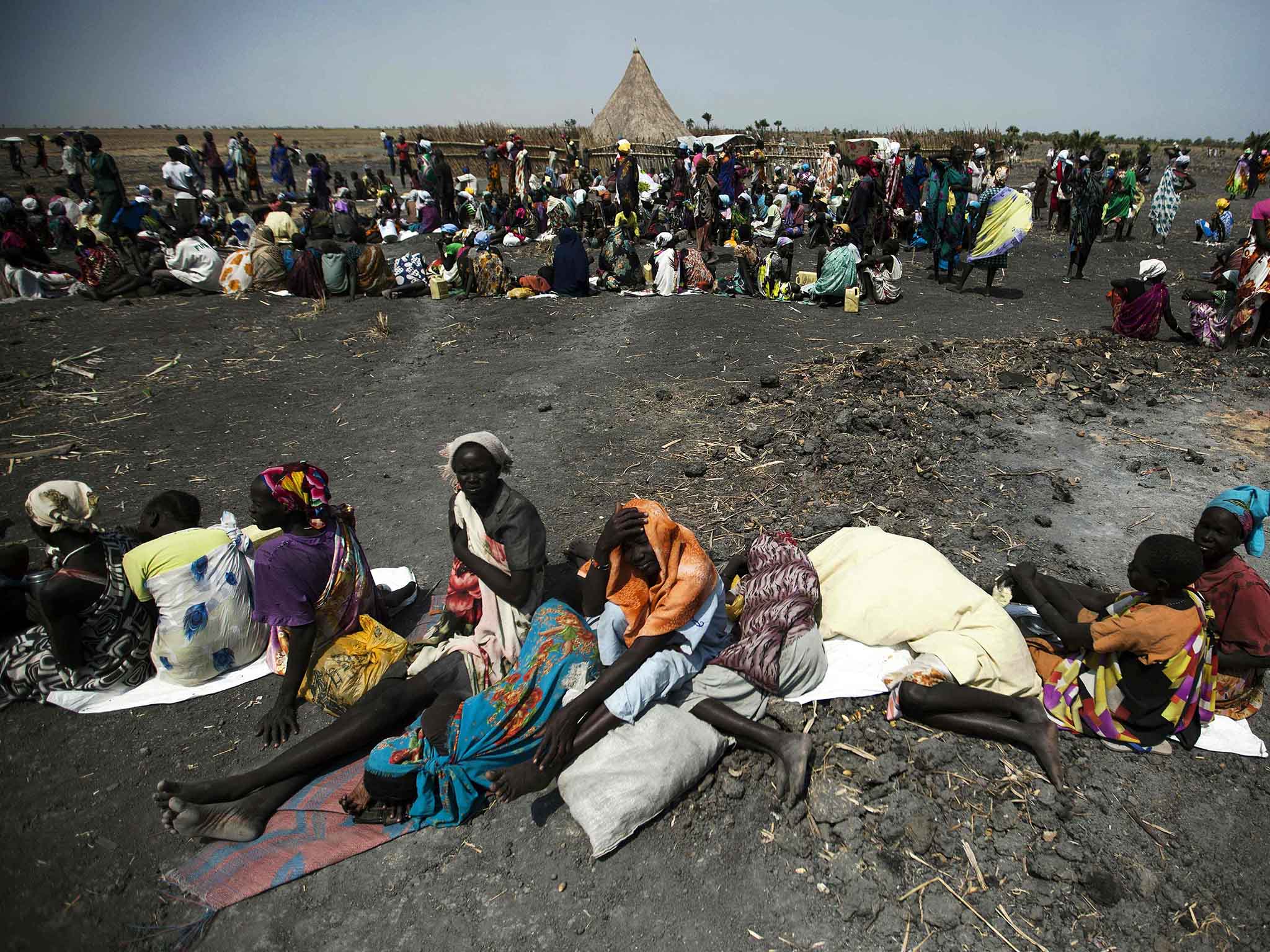 A large number of people wait for food air-drops by ICRC (International Committee of the Red Cross), outside Thonyor, in South Sudan, on February 3, 2016.