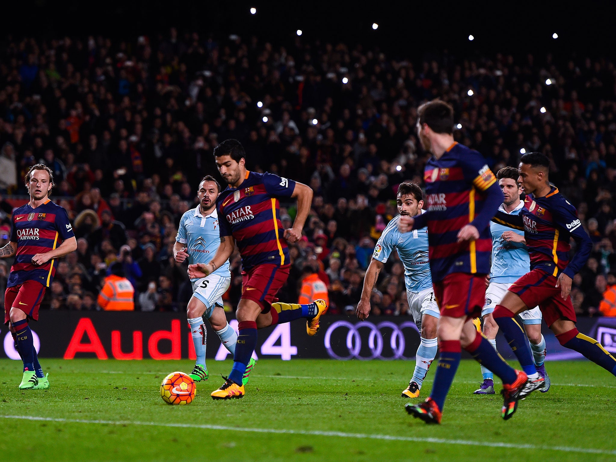 Luis Suarez runs into the penalty area to shoot at goal after Lionel Messi's pass