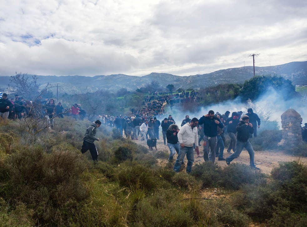 Tear gas is fired as people protest against the so-called "hotspot" being built for refugees and migrants on the Aegean island of Kos
