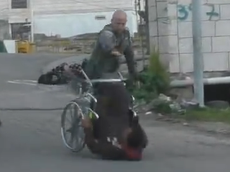 Israeli policeman filmed pushing Palestinian man out of wheelchair