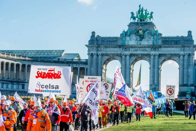 Steel workers march through the Arcade du Cinquantenair in Brussels