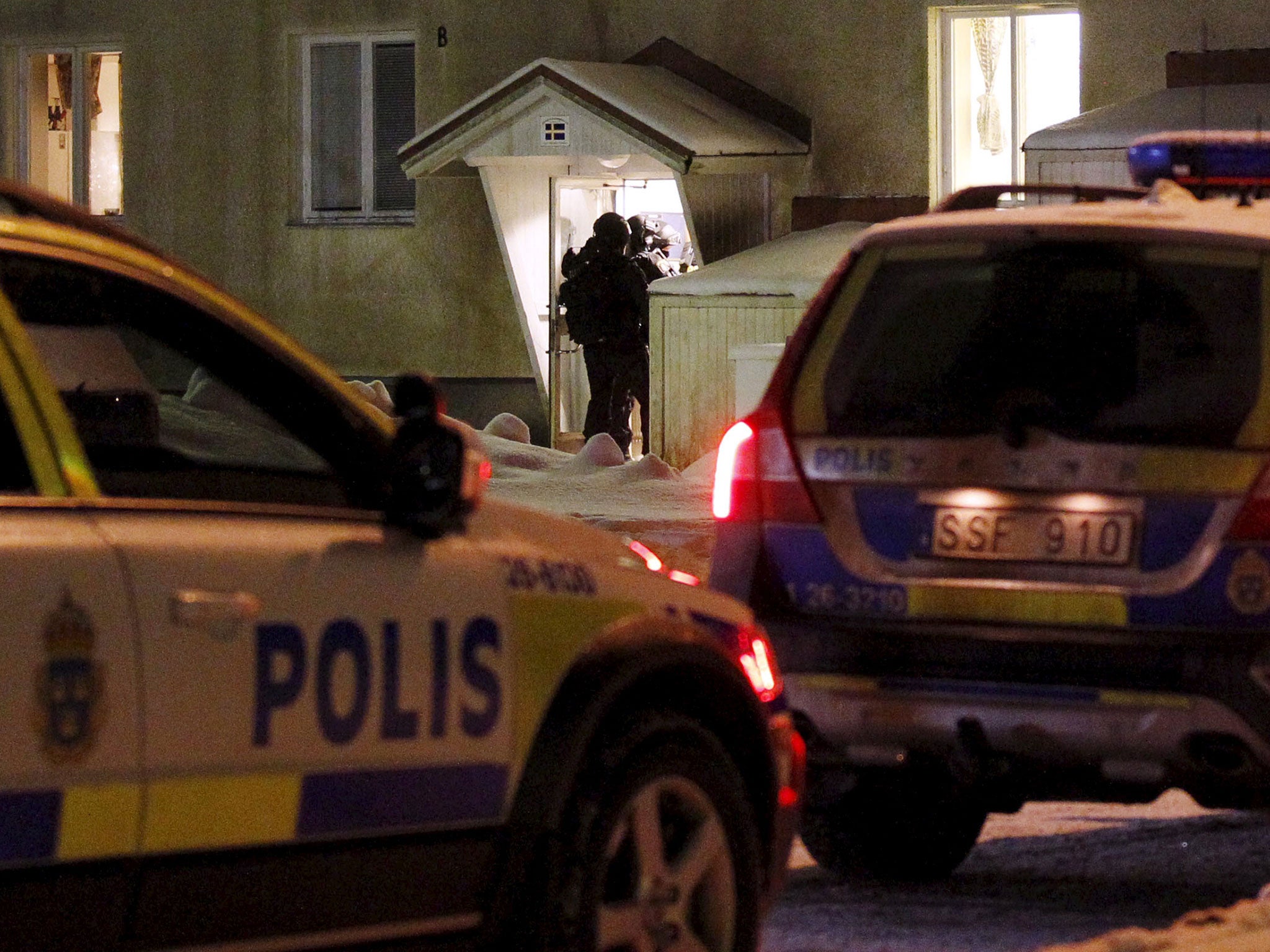 Heavily armed police prepare to enter an asylum center in Ljusne in northern Sweden on 13 February, 2016, after a deadly stabbing