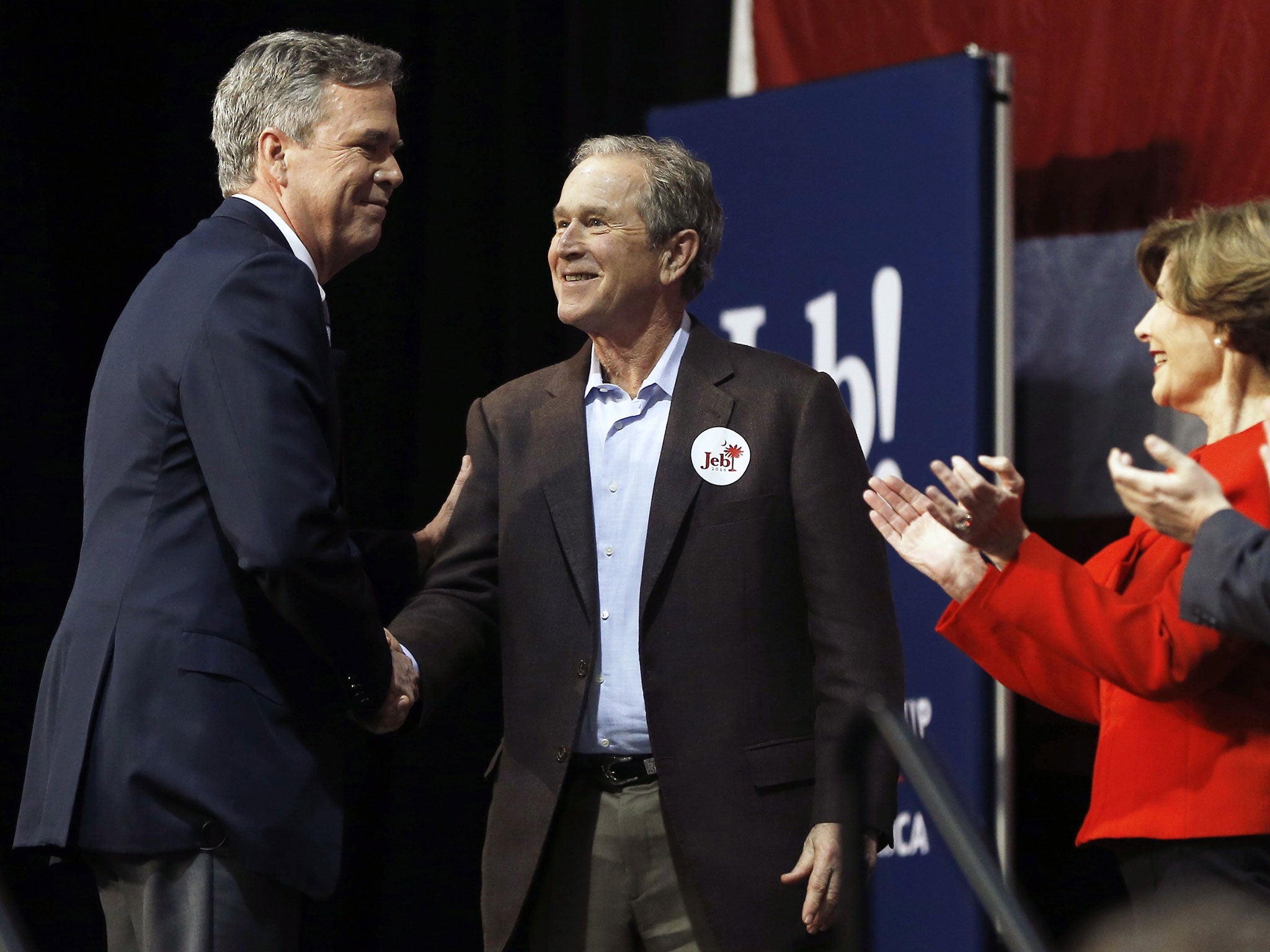 Republican presidential candidate and former Florida Gov. Jeb Bush, left, shakes hands with his brother former President George W. Bush