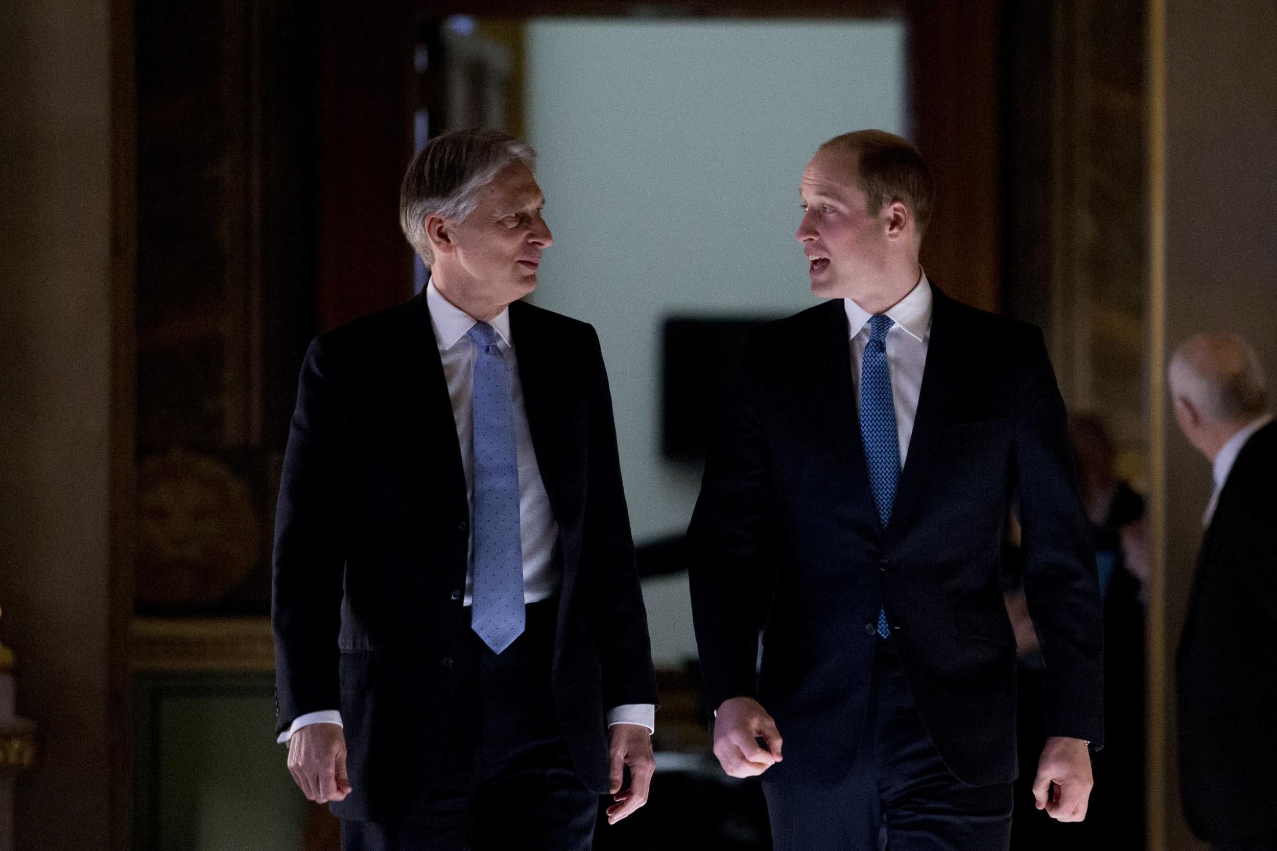Prince William walks with Foreign Secretary Philip Hammond as he visits the Foreign and Commonwealth Office