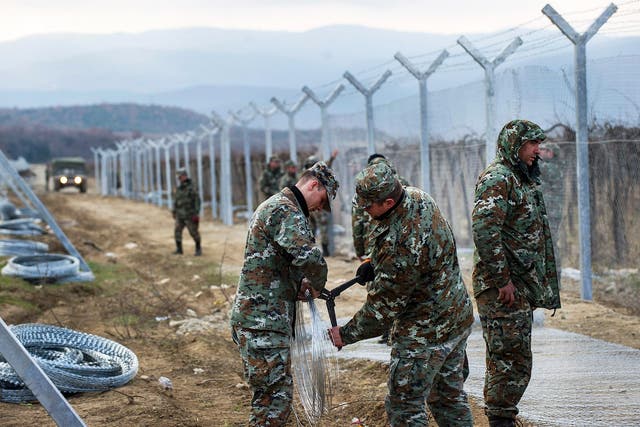Macedonian soldiers build a second border fence to prevent illegal crossings by migrants at the border with Greece