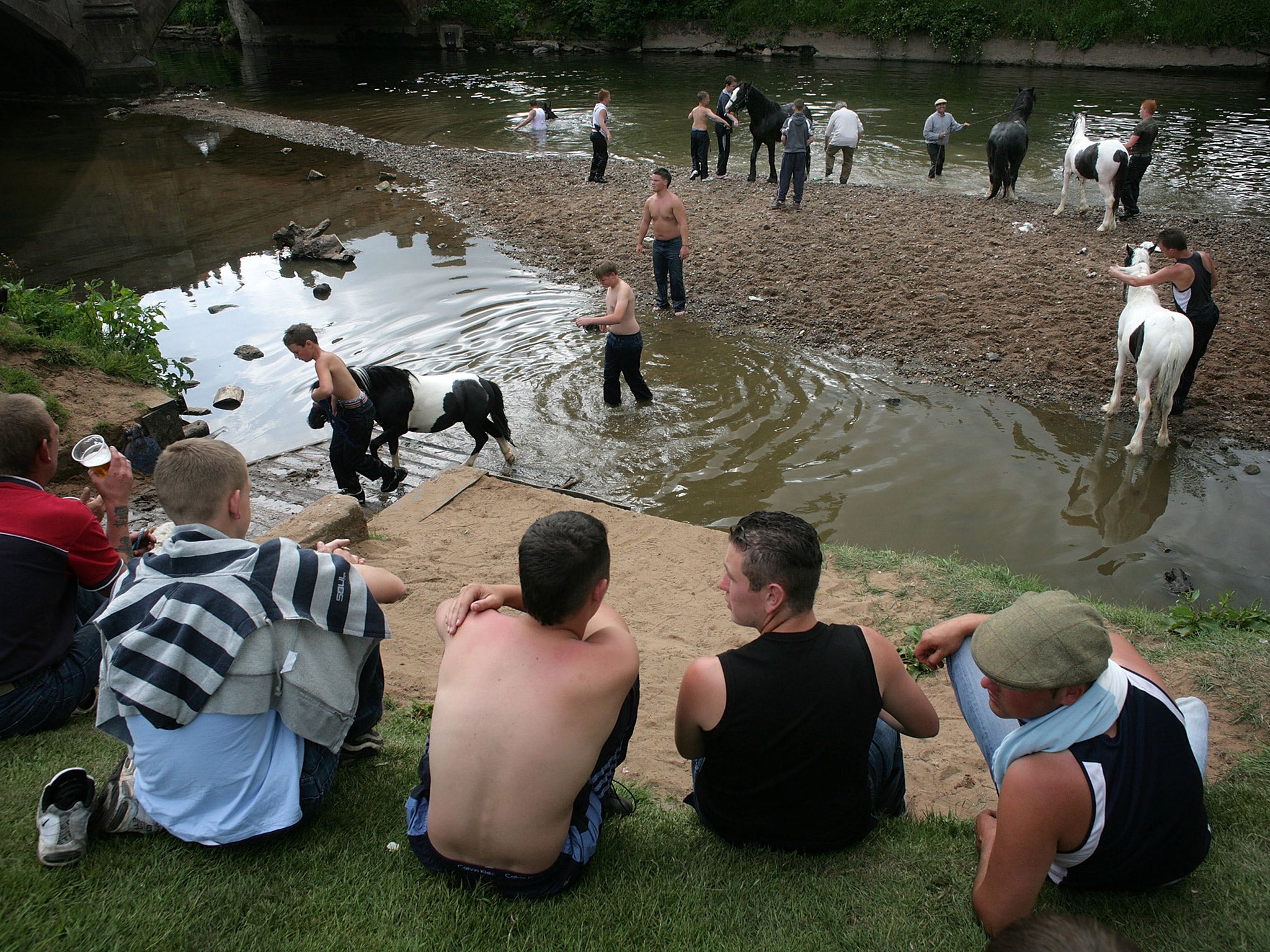 Gypsies wash their horses in the River Eden at the Appleby Horse Fair