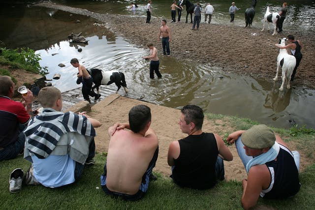 Gypsies wash their horses in the River Eden at the Appleby Horse Fair