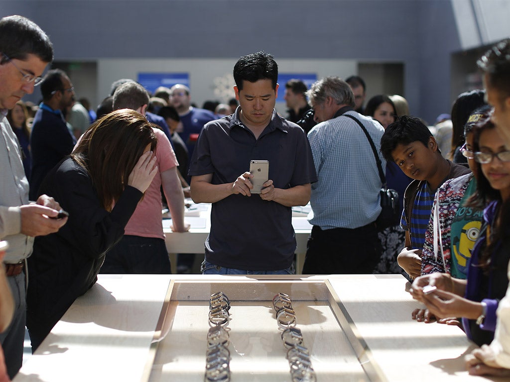 People viewing products at an Apple Store in Palo Alto, California (Getty)