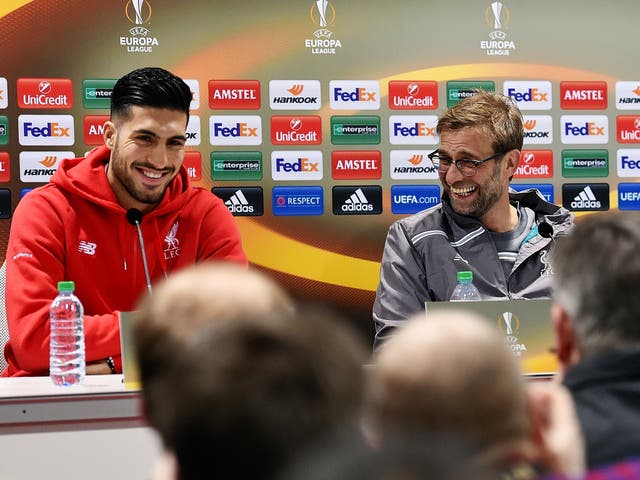 Jürgen Klopp (right) and Emre Can share a light-hearted moment during a press conference in Augsburg