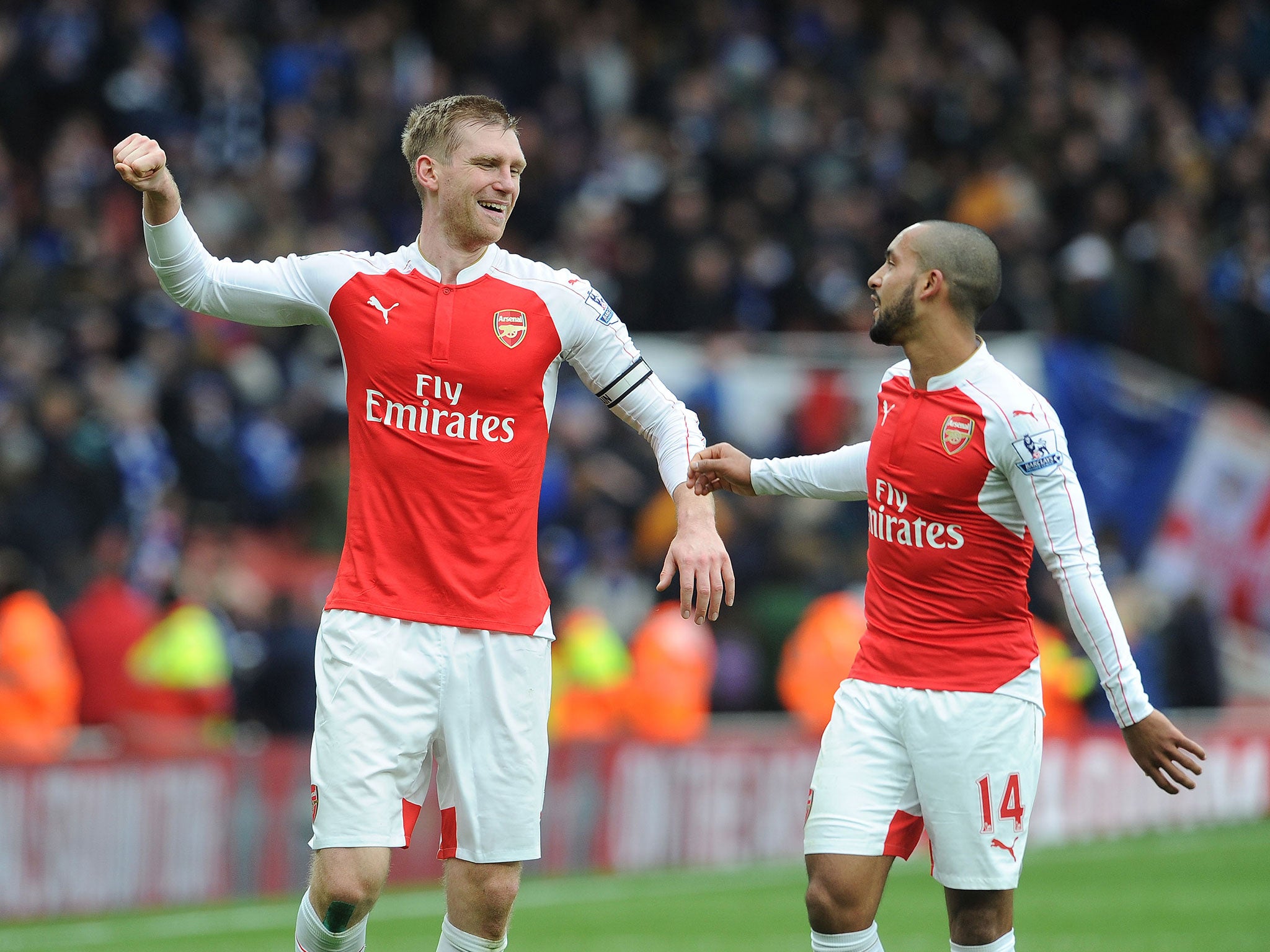 Per Mertesacker celebrates with Theo Walcott during the 2-1 win over Leicester