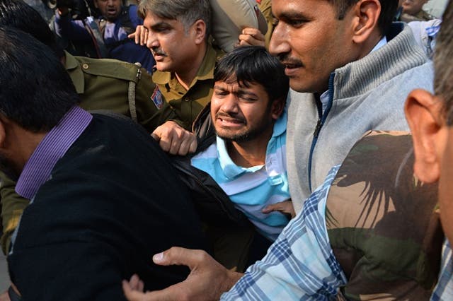 JNU students' union leader Kanhaiya Kumar, centre, is escorted by police into Patiala Court for a hearing in New Delhi on 17 February amid escalating protests