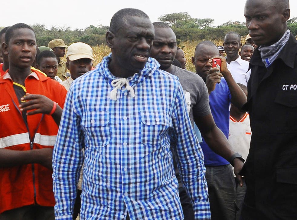 Uganda's Opposition leader Kizza Besigye, center, meets his supporters after casting his vote at a polling station near his country home in Rukungiri, about 700 kilometres west of Kampala