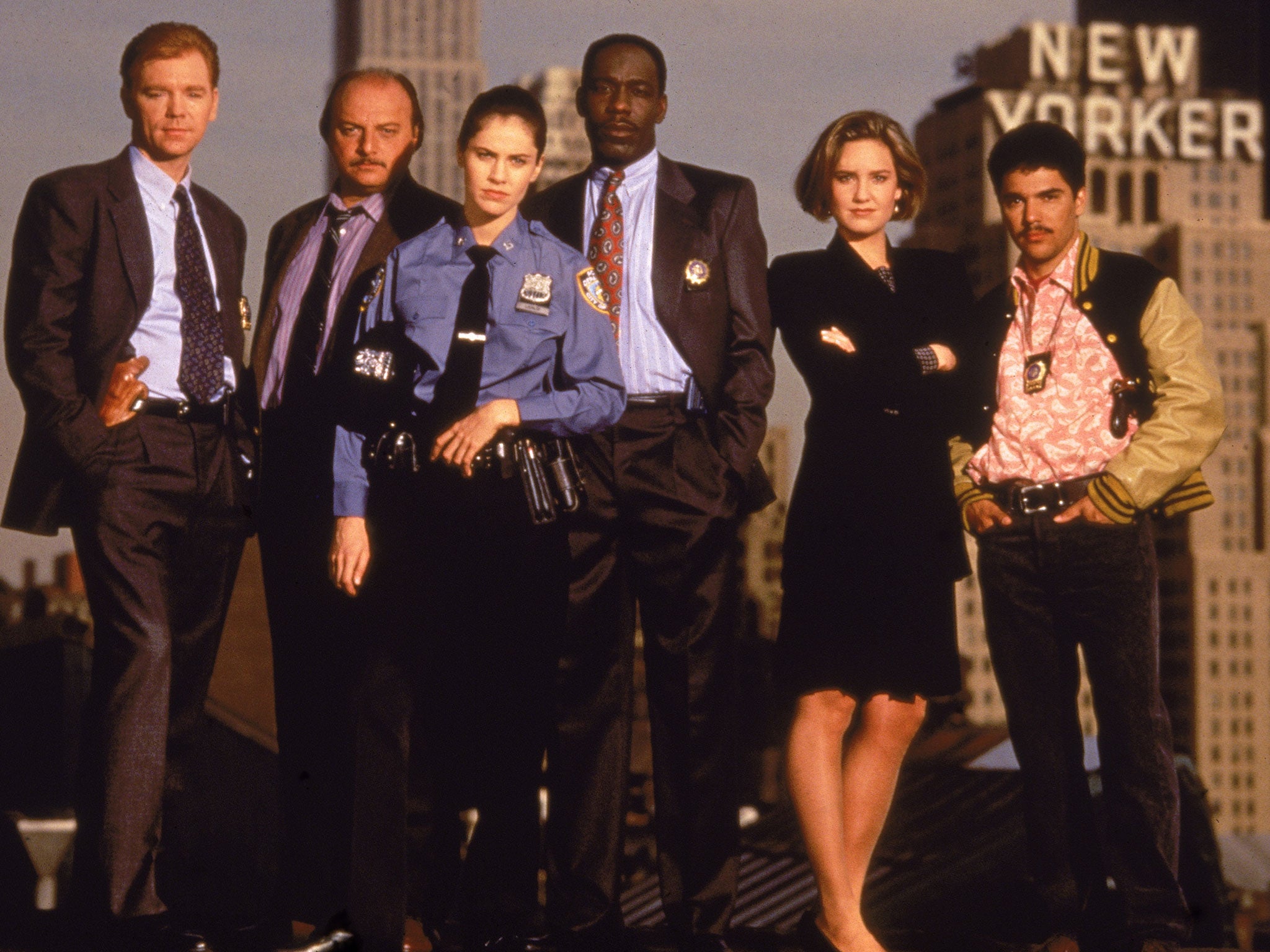 The cast of the television police drama 'NYPD Blue' pose on top of a roof in New York