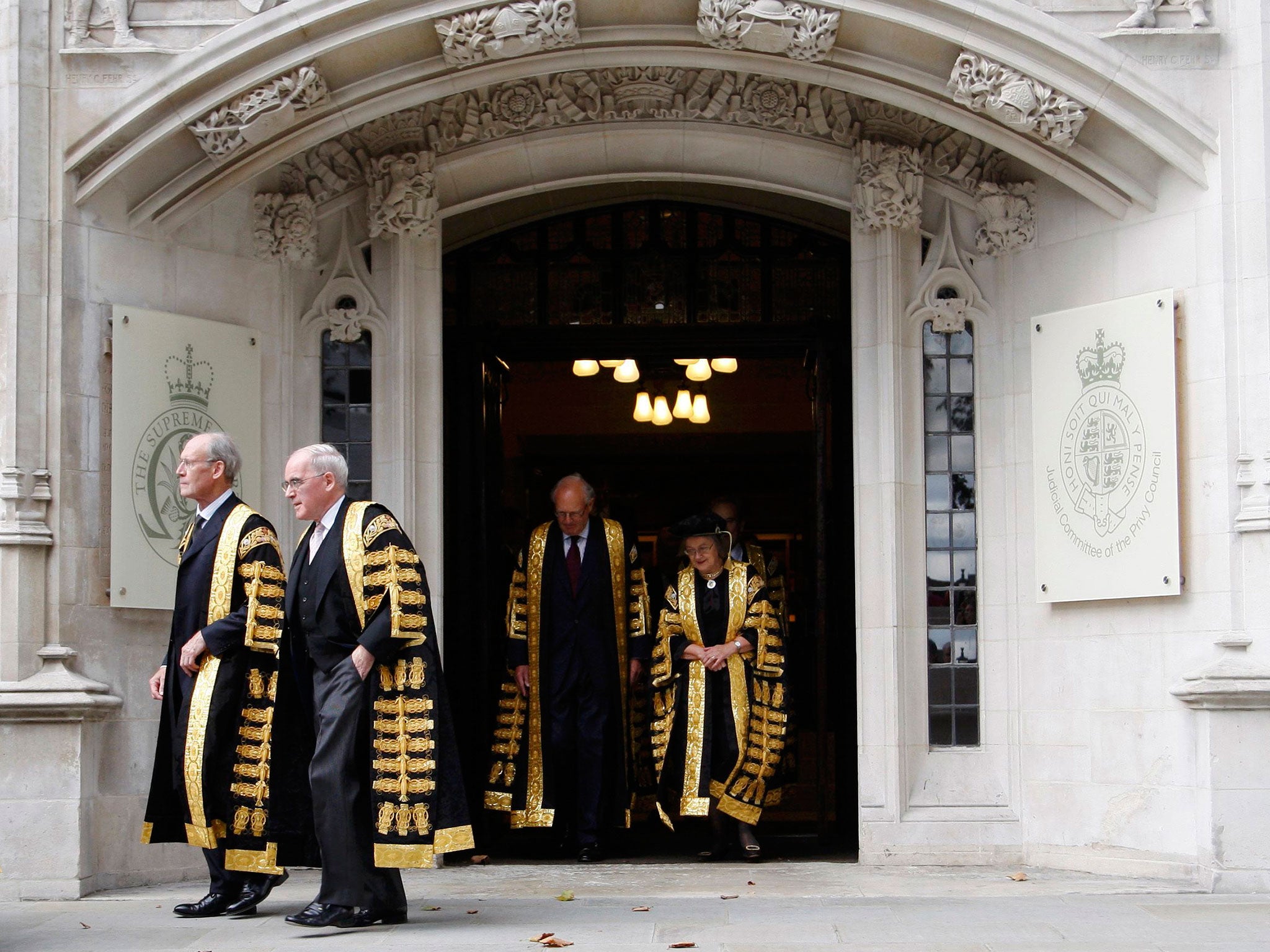 Justices of the Supreme Court leave the Supreme Court of the United Kingdom in Parliament Square, London